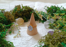 Load image into Gallery viewer, Ring with a floral design on a small beige cone surrounded by greenery