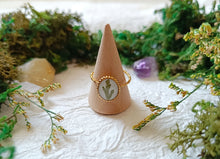 Load image into Gallery viewer, Ring on a decorative cone with greenery and stones in the background

