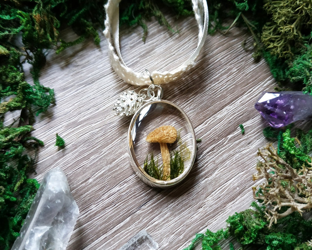 Mushroom pendant with a pinecone charm